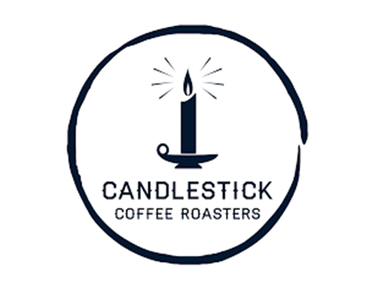 Expert hands roast coffee beans at Candlestick Coffee Roasters, capturing the essence of Northern New Mexico's tradition.