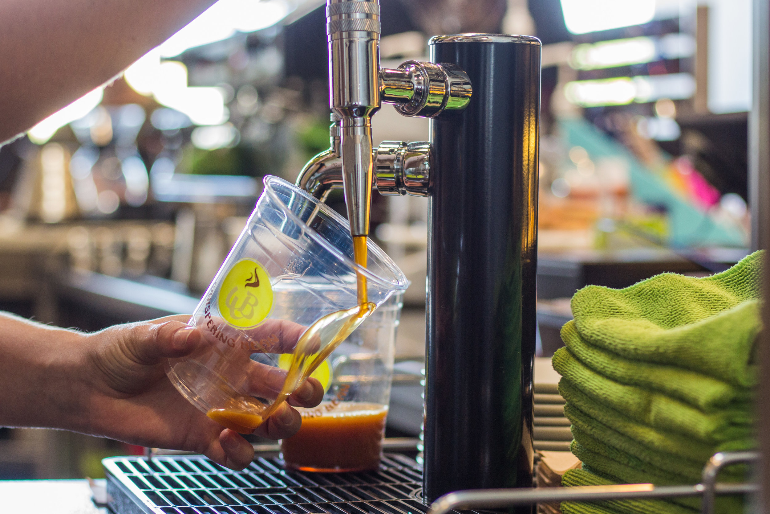 Cold brew ready to be served at Whispering Bean Coffee Roasters, showcasing their diverse coffee selection.